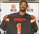  ?? The Associated Press ?? Former Texas A&M defensive end Myles Garrett holds up a Cleveland Browns jersey Thursday in Arlington,Texas, after the Browns made him the No. 1 pick in the NFL draft.
