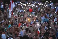  ?? (AP/Dmitri Lovetsky) ?? Opposition supporters display their phone lights Tuesday during a protest in front of the government building at Independen­t Square in Minsk, Belarus.