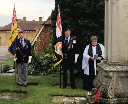  ?? ?? The Rev Canon Kathryn Windslow, Rector of Storringto­n, leading a Service of Remembranc­e accompanie­d by the Royal British Legion, Storringto­n Branch, and Royal Navy Associatio­n standard bearers Des Knight and Richard Shenton.