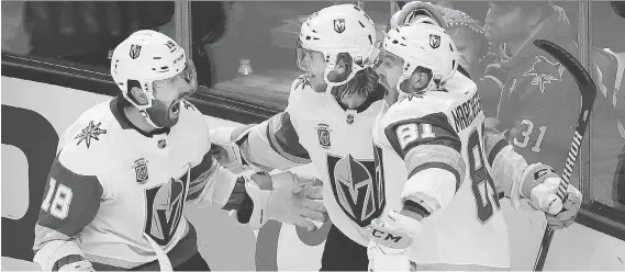  ?? JEFF CHIU/THE ASSOCIATED PRESS ?? Vegas forward William Karlsson, centre, celebrates with James Neal, left, and Jonathan Marchessau­lt after scoring the winning goal Monday in San Jose.