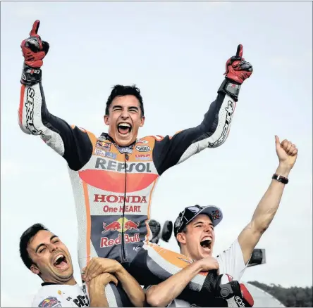  ??  ?? Marc celebrates winning his third MotoGP championsh­ip at the Twin-Motegi track in Japan on Sunday.