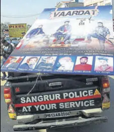  ?? HT PHOTO ?? Police taking away the poster of a music album by Rocky Bhatti near Government Ranbir College in Sangrur on Wednesday.