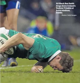  ?? Photos / Getty Images ?? All Black Ben Smith drags down Ireland’s Andrew Trimble at Aviva stadium, Dublin.