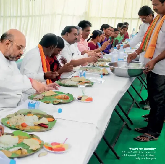  ??  ?? WHAT’S FOR DESSERT? BJP chief Amit Shah having lunch at a Dalit colony in Theratpall­y village, Nalgonda, Telangana