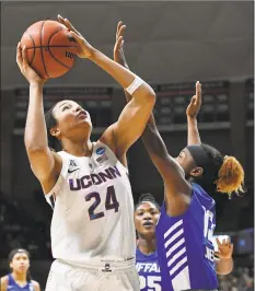  ?? Jessica Hill / Associated Press ?? UConn’s Napheesa Collier, left, shoots over Buffalo’s Autumn Jones during an NCAA Tournament secondroun­d game on March 24.