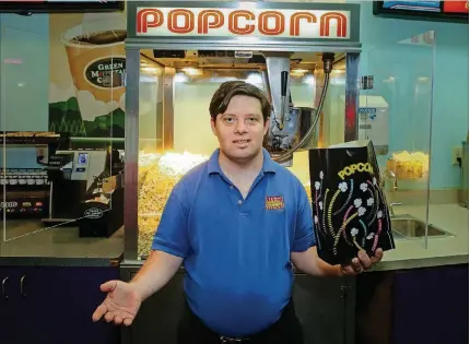  ?? HIGGINS / THE PALM BEACH POST ?? Zack Gottsagen, 33, who has Down syndrome, stands inside the Alco Boynton Cinema recently in Boynton Beach. Gottsagen is starring in the upcoming film “The Peanut Butter Falcon” that was designed with him in mind, along with big Hollywood names Shia...