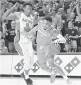  ??  ?? Tennessee guard Lamonte Turner, right, drives past Florida guard KeVaughn Allen during Saturday's game.