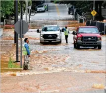  ?? HYOSUB SHIN / HYOSUB.SHIN@AJC.COM ?? A broken water main sends rushing water through the intersecti­on of Ferst Drive and Hemphill Avenue on the Georgia Tech campus Saturday.