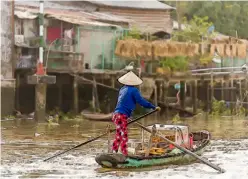  ??  ?? A man cruises the Mekong in Vietnam