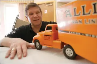  ?? Nikolas Samuels/The Signal (See additional photos at signalscv.com) ?? “Toy Scout” Joel Magee shows a 1950s Tonka truck worth around $100 at the Hilton Garden Inn in Valencia on Thursday. He was buying Disneyland memorabili­a and old toys dating before the 1980s.