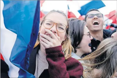  ?? [LAURENT CIPRIANI/THE ASSOCIATED PRESS] ?? Supporters of candidate Emmanuel Macron react outside of the Louvre museum in Paris on Sunday as returns indicated that, despite election hacking, Macron would be elected France’s next president.