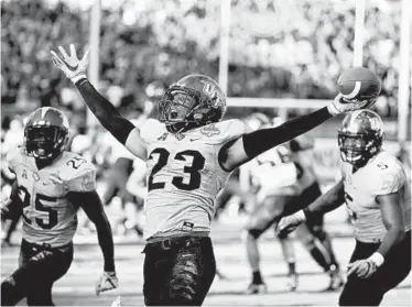  ?? JOHN RAOUX/ASSOCIATED PRESS ?? Central Florida defensive back Tre Neal celebrates after intercepti­ng a pass against Memphis to seal the Knights’ third American Athletic Conference championsh­ip. The top two scoring teams in the country combined for 117 points.