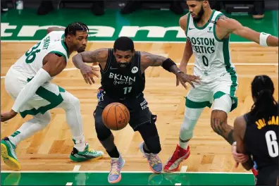  ?? LOSING CONTROL: The Associated Press ?? Brooklyn Nets’ Kyrie Irving (11) loses control of the ball against Boston Celtics’ Marcus Smart (36) and Jayson Tatum (0) during the first half of Friday’s game in Boston.