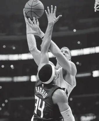  ?? Michael Owen Baker, The Associated Press ?? Nuggets center Mason Plumlee shoots over Clippers forward Tobias Harris during Saturday’s game at the Staples Center in Los Angeles. Plumlee scored 11 points.
