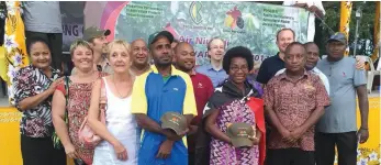  ??  ?? Cocoa show … (this page, clockwise from top left) an Ilugi farmer showing off his cocoa pods at the inaugural Cocoa of Excellence Show; more pods; a PNG flag flying on a cocoa float; winners and organisers at the show; (opposite page) a mouth-watering...