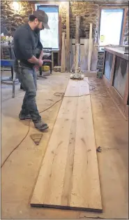  ??  ?? Anton Altrichter, operations manager for the Liberty family of bars and restaurant­s, with the floor boards he has salvaged from the former Dryville Inn and turned into a bar top for the newest location, Liberty at Dryville.