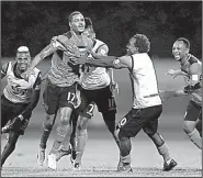  ?? AP/REBECCA BLACKWELL ?? Trinidad and Tobago’s Alvin Jones (17) celebrates with teammates after scoring a goal during a 2-1 victory over the United States on Tuesday in Couva, Trinidad. The loss eliminated the U.S. from World Cup contention.