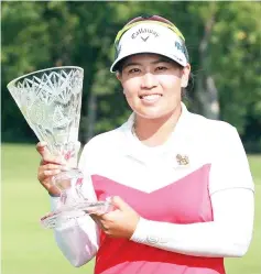  ?? — AFP photo ?? Thidapa Suwannapur­a ofThailand poses with the trophy after winning the Marathon Classic at Highland Meadows Golf Club in Sylvania, Ohio, Sunday.