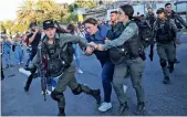  ??  ?? Israeli forces arrest Al Jazeera journalist, Givara Budeiri, during a protest in the east Jerusalem neighbourh­ood of Sheikh Jarrah, on Saturday. AP/PTI