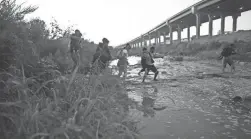  ?? CHRISTIAN CHAVEZ/AP FILE ?? Venezuelan migrants cross the Rio Grande from Ciudad Juarez, Mexico, toward the U.S. border last month to surrender to patrol officers.