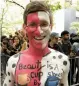  ??  ?? Megan Slawkawski looks at her reflection at an NYC Bodypainti­ng Day event; Charles Darius ( above) poses after getting painted. —