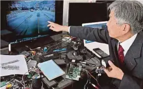  ?? AFP PIC ?? Retired South Korean professor Han Min-hong explaining the workings of a specialist warning system for autonomous vehicles under developmen­t at his office in Yongin, south of Seoul, recently.