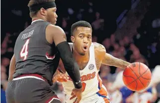  ?? GETTY IMAGES ?? Florida’s Kasey Hill of the Florida Gators drives to the basket against Rakym Felder of the South Carolina Gamecocks during Sunday’s game.