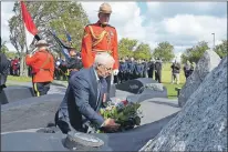  ?? LOUIS POWER/THE TELEGRAM ?? Lt.-Gov. Frank Fagan lays a wreath Sunday with RCMP Const. David Smith at the Police and Peace Officers’ Memorial.