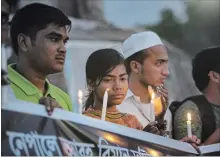  ?? ALLISON JOYCE
GETTY IMAGES ?? People attend a candleligh­t vigil for the victims of the Nepal plane crash.