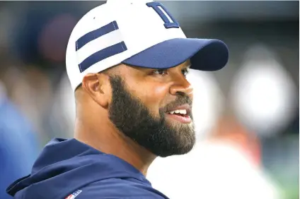  ?? Ron Jenkins/Associated Press ?? ■ Dallas Cowboys assistant coach Kris Richard walks on the field before a preseason NFL game Saturday in Arlington, Texas. Richard is the former defensive coordinato­r for the Legion of Boom in Seattle.