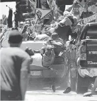  ?? RYAN M. KELLY / THE DAILY PROGRESS VIA THE ASSOCIATED PRESS FILES ?? People fly into the air as a vehicle drives into a group of protesters demonstrat­ing against a white nationalis­t rally in Charlottes­ville, Va. last August.