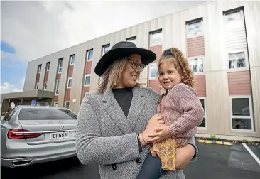  ?? JOSEPH JOHNSON/STUFF ?? Taylor Tuhaka and daughter Harper outside the apartment block which opened yesterday at Rehua Marae. They are moving into one of the apartments.