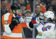  ?? TOM MIHALEK — THE ASSOCIATED PRESS ?? The Philadelph­ia Flyers’ Brandon Manning, left, fights with the New York Rangers’ Mats Zuccarello after Zuccarello shoved his stick in Manning’s face Saturday.