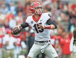  ?? BRETT DAVIS/AP FILE ?? Georgia quarterbac­k Carson Beck throws in the first half of Georgia’s spring game last year in Athens, Ga. Coach Kirby Smart has made it clear that Carson Beck is the quarterbac­k to beat.