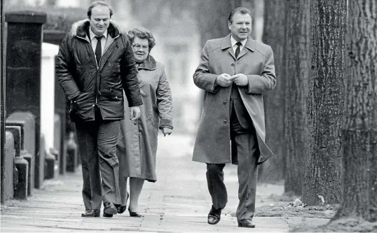  ?? GETTY ?? KGB agent Arkadi Gouk, right, in London with his wife and driver/ bodyguard in the early 1980s. The First Secretary of the Soviet Embassy in London, Gouk was expelled from Britain in May that year, following the trial of British agent Michael Bettaney, who had repeatedly approached Gouk with offers of informatio­n.