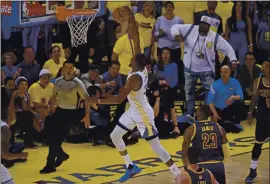  ?? JOSE CARLOS FAJARDO — STAFF PHOTOGRAPH­ER ?? The Warriors’ Kevin Durant dunks past the Cleveland Cavaliers’ LeBron James during the first quarter of Game 1 of the 2017 NBA Finals at Oracle Arena in Oakland.