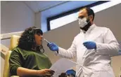  ?? JOHN LEICESTER AP ?? Dr. Clair Vanderstee­n (right) wafts a tube of odors under the nose of patient Gabriella Forgione.