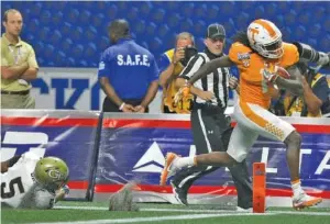  ?? STAFF PHOTO BY C.B. SCHMELTER ?? Tennessee wide receiver Marquez Callaway gets past Georgia Tech defensive back A.J. Gray as he races to the end zone for a touchdown during a Chick-fil-A Kickoff Game at Atlanta’s Mercedes-Benz Stadium in September 2017.
