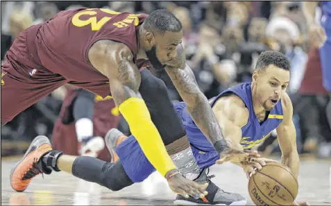  ?? TONY DEJAK / AP ?? The Cavaliers’ LeBron James (left) and the Warriors’ Stephen Curry hit the floor as they battle for a loose ball in Cleveland’s 109-108 win Sunday. James had 31 points and 13 rebounds, while Curry scored only 15 points.