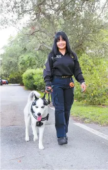  ?? Miami Herald-Tribune News Service ?? El Portal, Fla., officer Ronnie Hufnagel with Artic on July 25, 2017, after a ceremony where Artic was officially sworn in as a K-9 officer for the city.