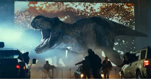  ?? Universal Pictures ?? A Tyrannosau­rus rex crashes a drive-in movie experience in the new film “Jurassic World: Dominion.”