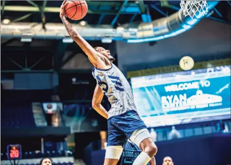  ?? URI Athletics ?? Ishmael El-Amin, son of former UConn star Khalid El-Amin, goes up for a dunk during Rhode Island’s Blue-White scrimmage. El-Amin will play for URI this season as a grad student.