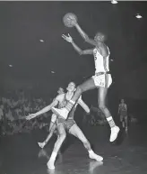  ?? Art Frisch / 1957 ?? Eugene “Gene” Brown goes to the hoop during a game against St. Mary’s at Kezar Pavilion in 1957. Brown won a title with the Dons in 1956.
