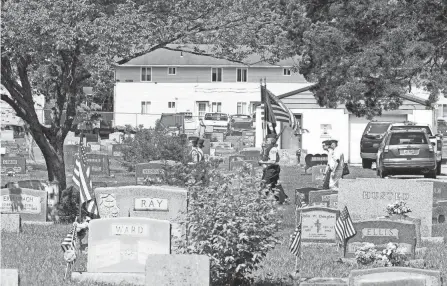  ?? ?? Members of the Grove City High School Navy J.R.O.T.C. head into the Grove City Cemetery for a Memorial Day service. Ceremonies returned after being called off because of the pandemic.