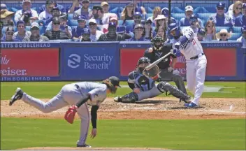  ?? MARK J. TERRILL/AP ?? LOS ANGELES DODGERS’ TEOSCAR HERNÁNDEZ (RIGHT) hits a two-run home run as Miami Marlins pitcher Ryan Weathers (left) and catcher Nick Fortes (second from left) watch along with home plate Alfonso Marquez during the sixth inning of a game on Wednesday in Los Angeles.