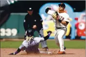  ?? KARL MONDON — STAFF PHOTOGRAPH­ER ?? The Rockies’ Raimel Tapia is out at second base as the Giants’ Donovan Solano turns a double play in the fifth.