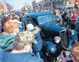  ?? KYLE TELECHAN/POST-TRIBUNE ?? Onlookers gather around a car stolen from former Lake County Sheriff Lillian Holley by John Dillinger as it pulls up to the Old Lake County Jail on Saturday.