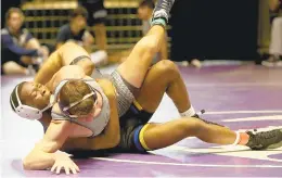  ?? STEVE EARLEY/STAFF ?? Sterling Waters, left, of Oscar Smith defeats Ocean Lakes’ Grant Manock at 152 pounds at Hampton Coliseum. Oscar Smith beat Great Bridge in the Black &amp; Blue final.