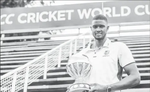  ??  ?? West Indies captain Jason Holder poses with the ICC World Cup qualifying tournament trophy. (Photo courtesy CWI Media)