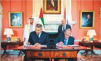  ?? WAM ?? Shaikh Mohammad Bin Zayed and Boris Johnson witness an expanded Sovereign Investment Partnershi­p MOU signing between Mubadala’s Khaldoon Khalifa Al Mubarak and UK Minister for Investment Gerry Grimstone in London yesterday.